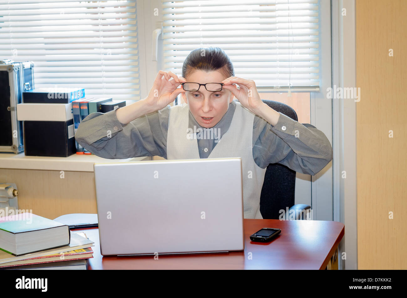 A fifty years old woman very angry with the modern technology Stock Photo