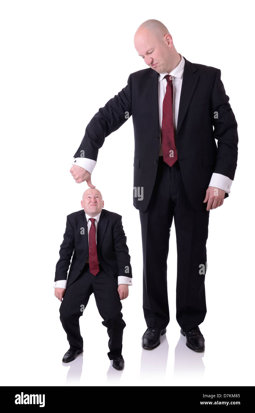 under the thumb businessman pushing down on a businessman isolated on white Stock Photo