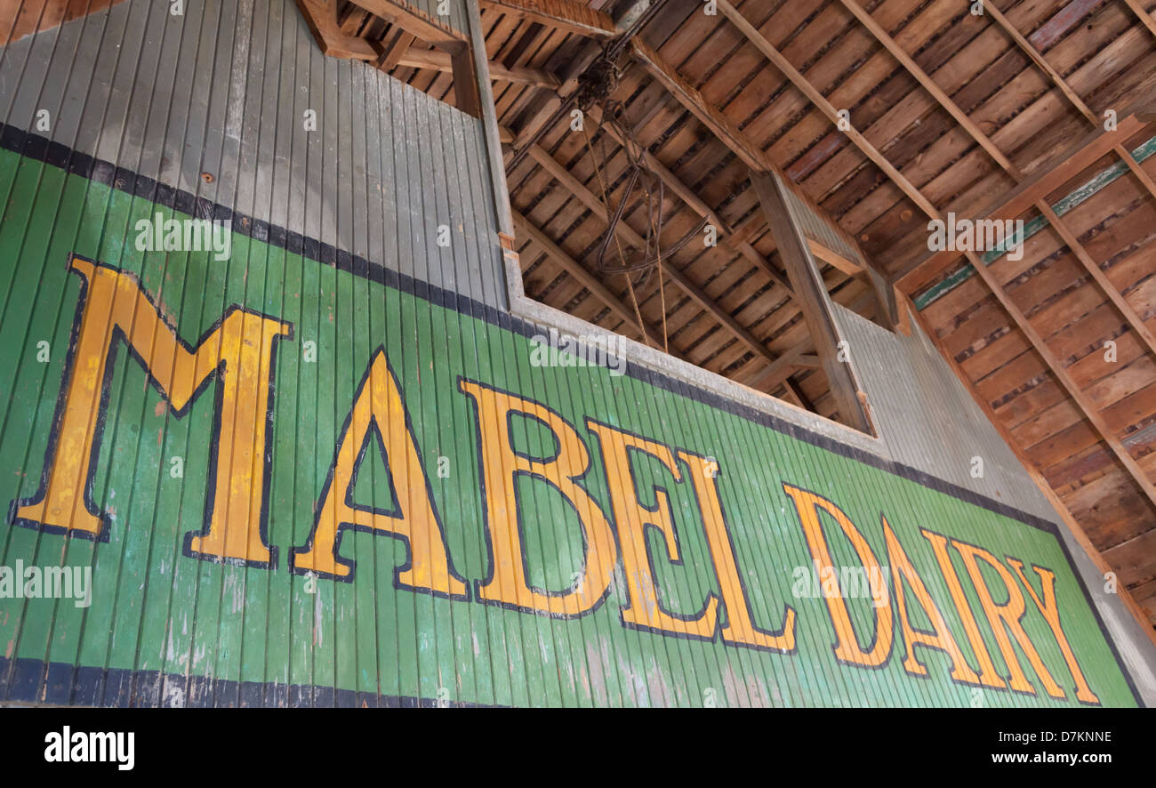 A battered, weathered Mabel Dairy sign on a farm in Mabel, Minnesota USA Stock Photo