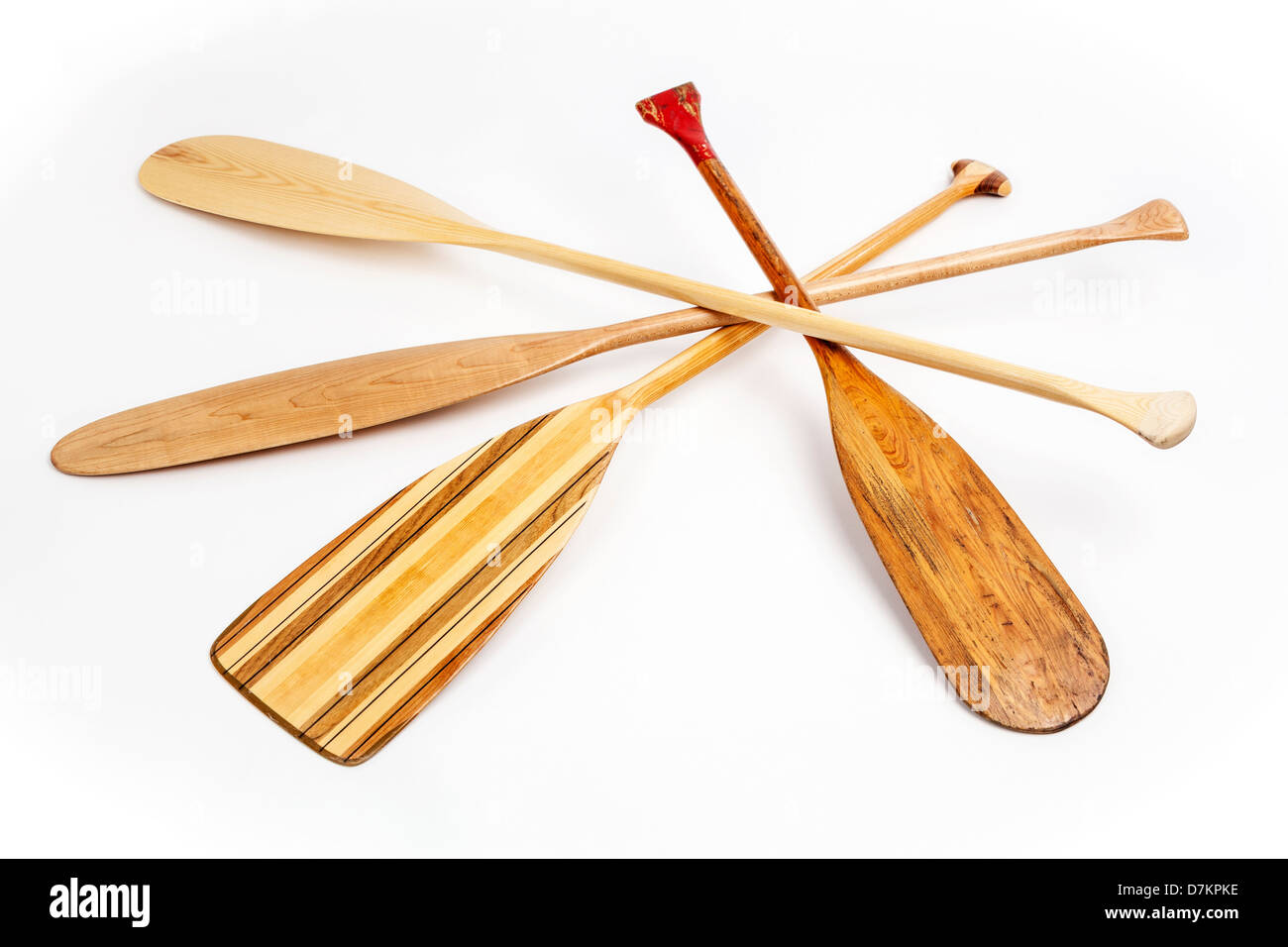 wooden canoe paddles of different shapes and sizes including a classic