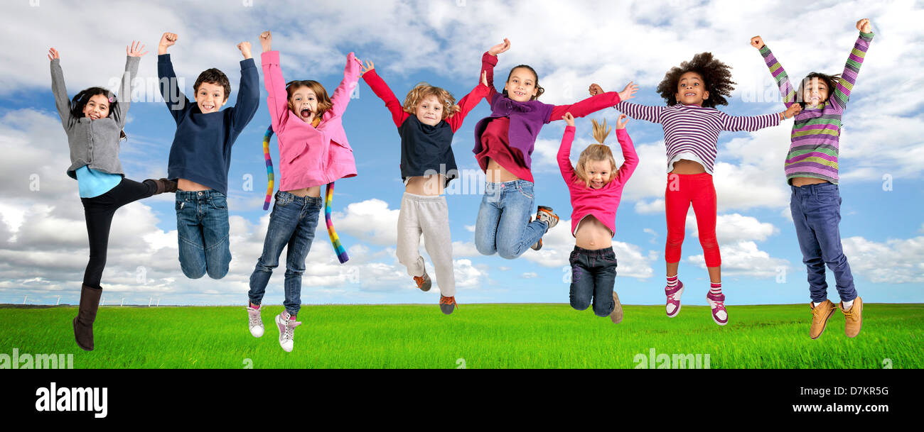 Group of children jumping outdoors Stock Photo - Alamy