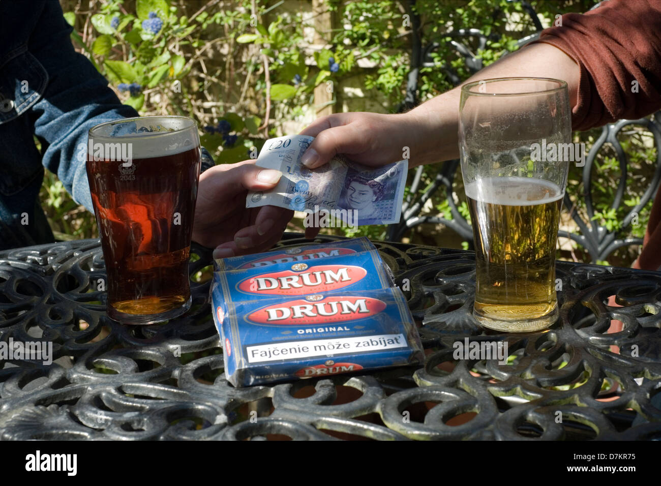 buying and selling of smuggled cigarette tobacco in a pub garden Stock