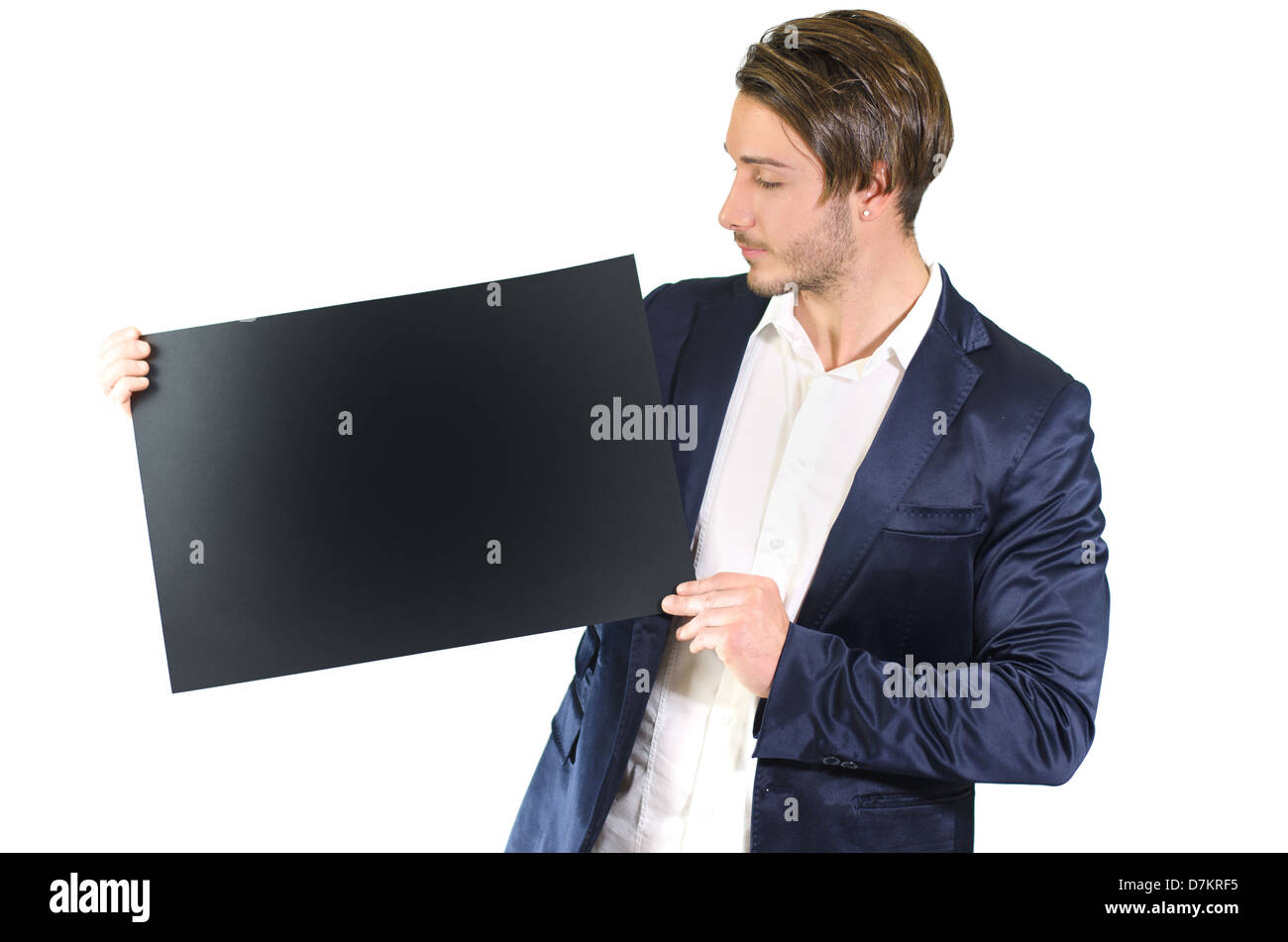Attractive young man holding and showing empty, blank black board, sign or paper sheet Stock Photo