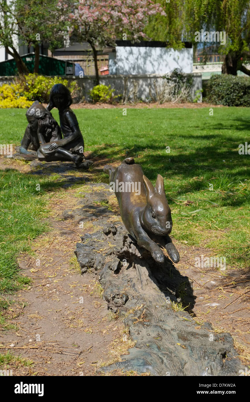 The sculpture 'Alice and the White Rabbit' by artist Edwin Russell. Guildford, Surrey. Stock Photo