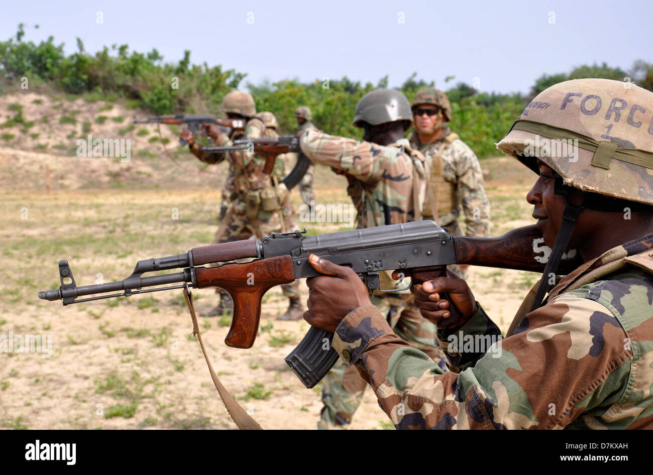 Soldiers with the Armed Forces of Liberia during firing practice as a US Marine mentor provides instruction during a combat marksmanship program at Edward Binyah Kesselly Military Barracks April 26, 2013 in Monrovia, Liberia. Stock Photo