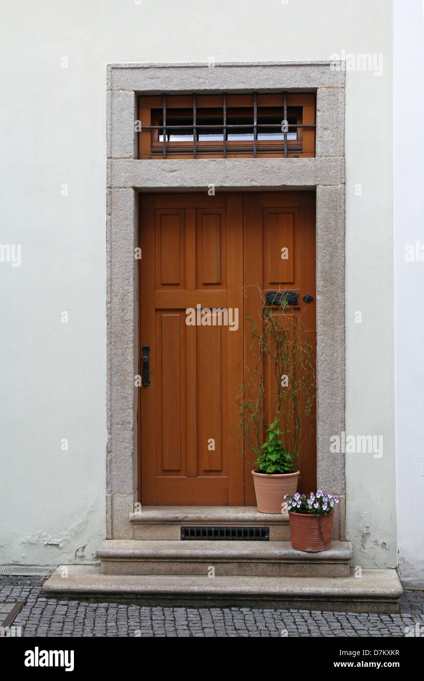 wooden door with stairs and flower in pots Stock Photo - Alamy