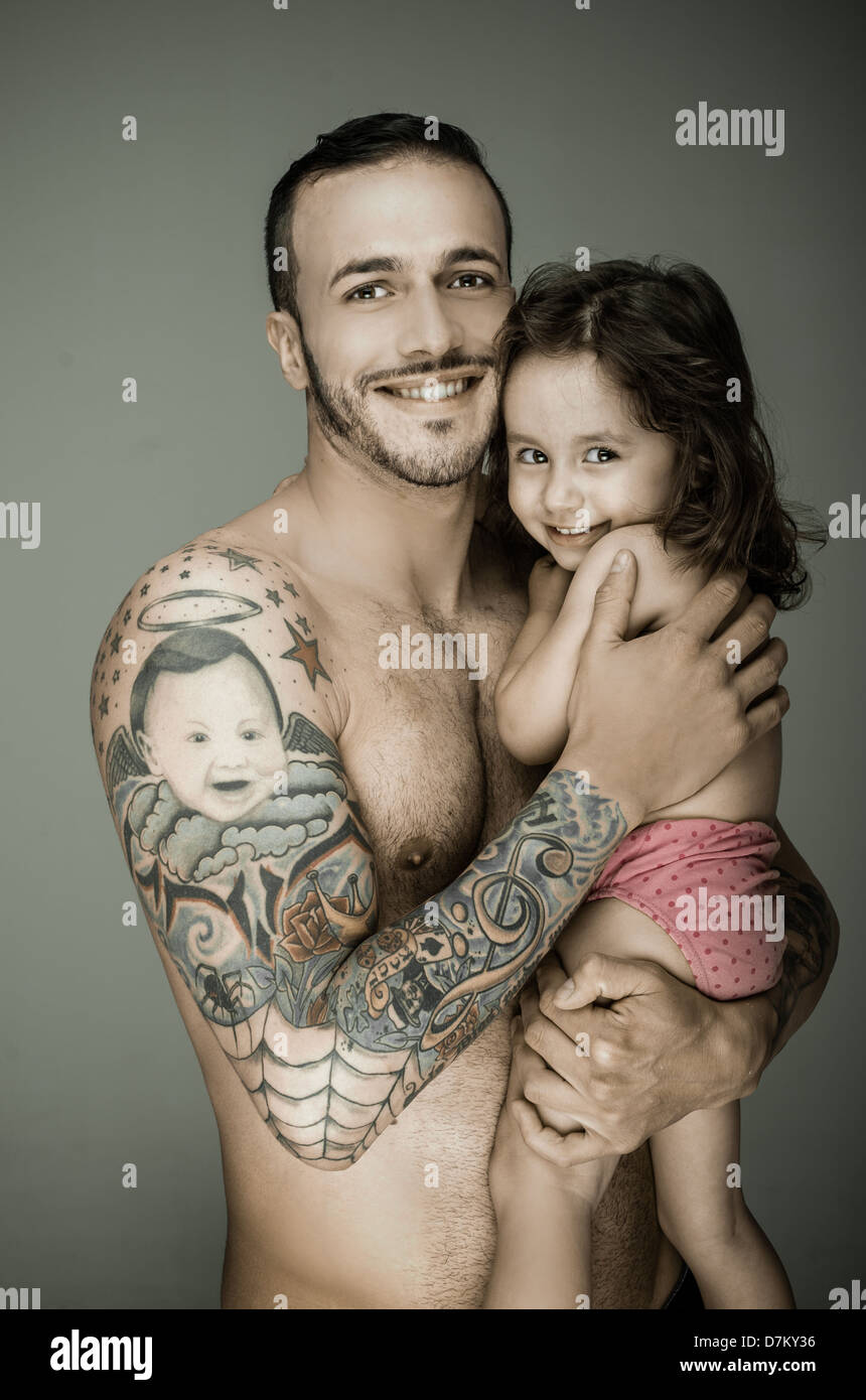 Father and daughter, man with tattoo Stock Photo - Alamy
