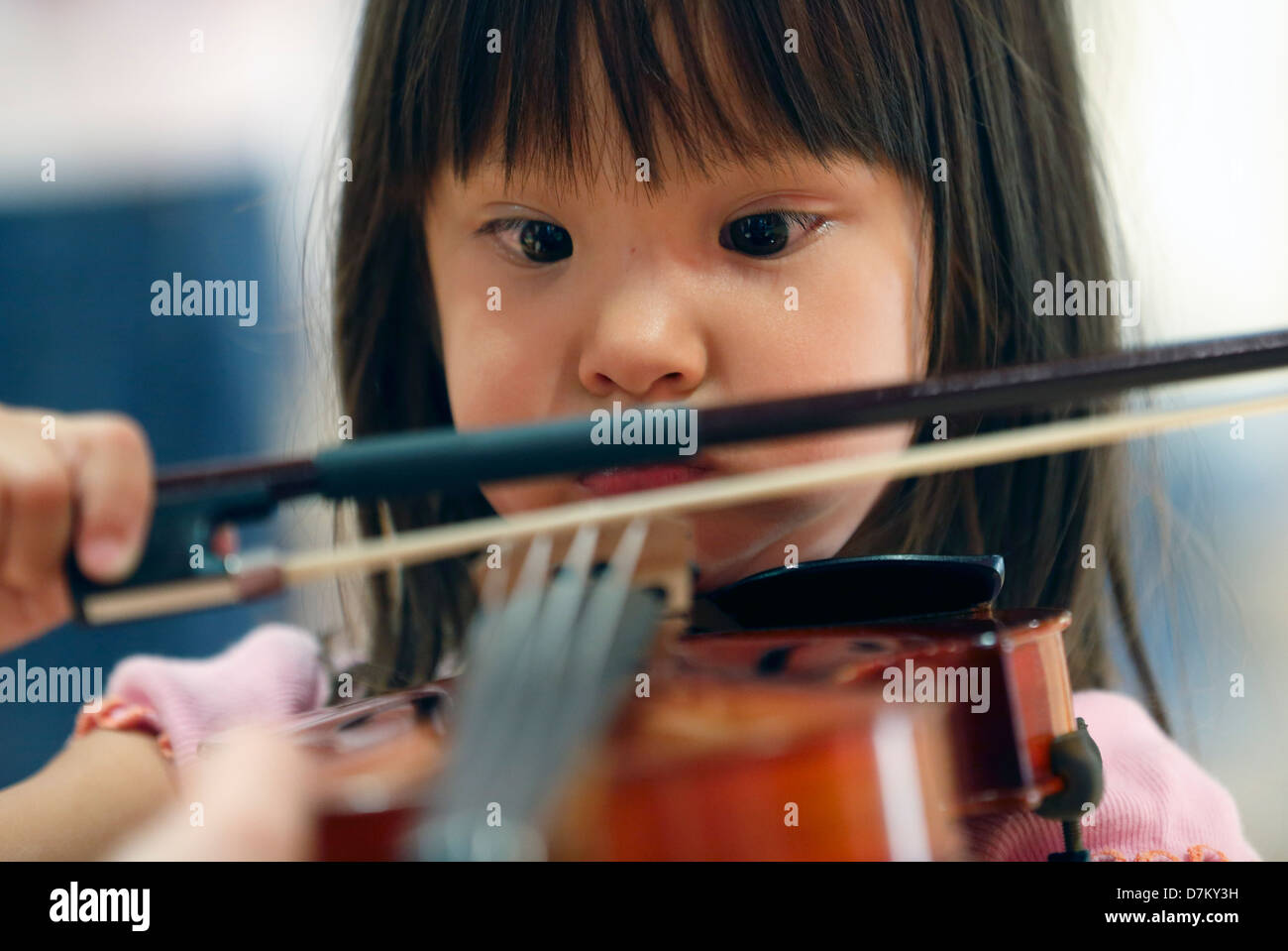 A child tries out a violin at the Children's Museum in Boston