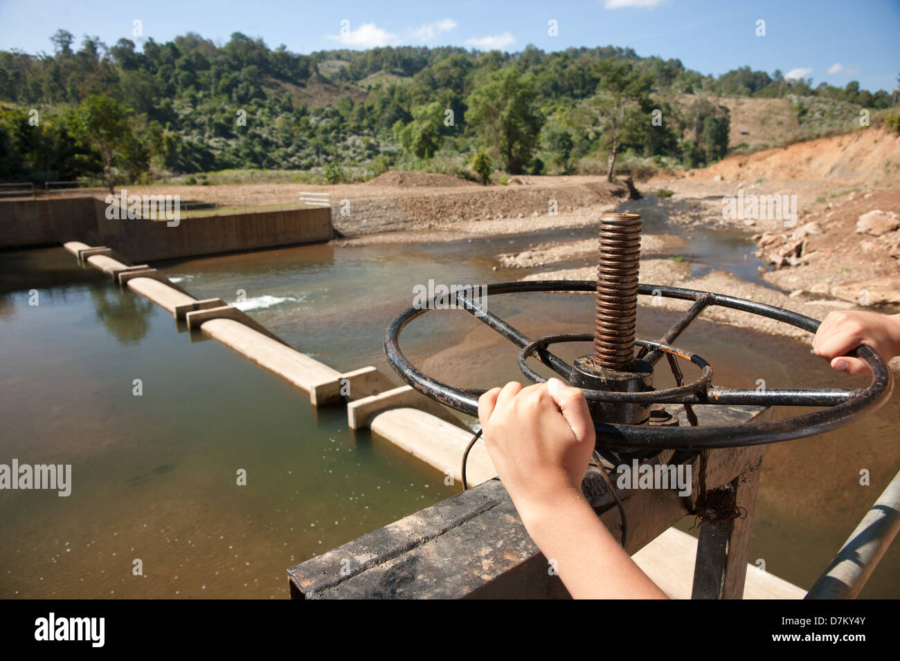release wheel on small dam in northern thailand Stock Photo