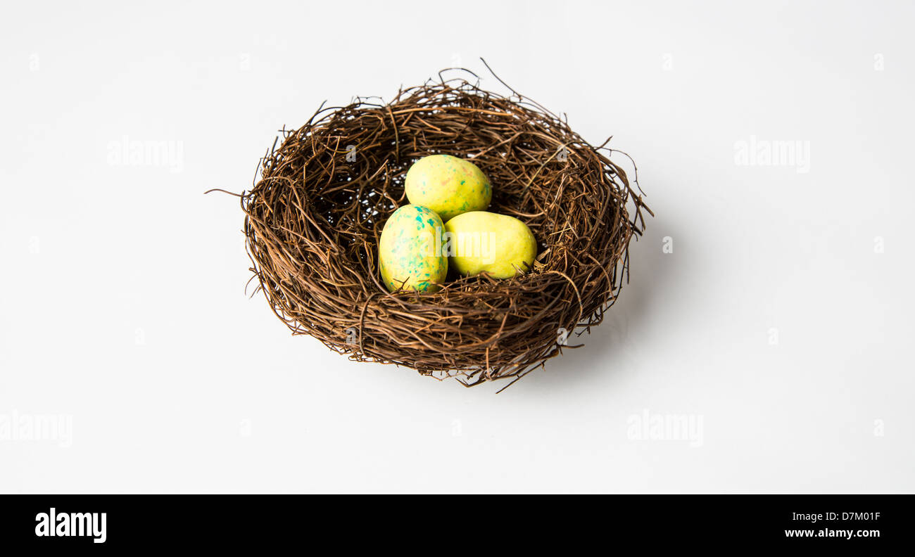 A nest of yellow bird eggs in a nest. Chocolate easter candy. Isolated ...