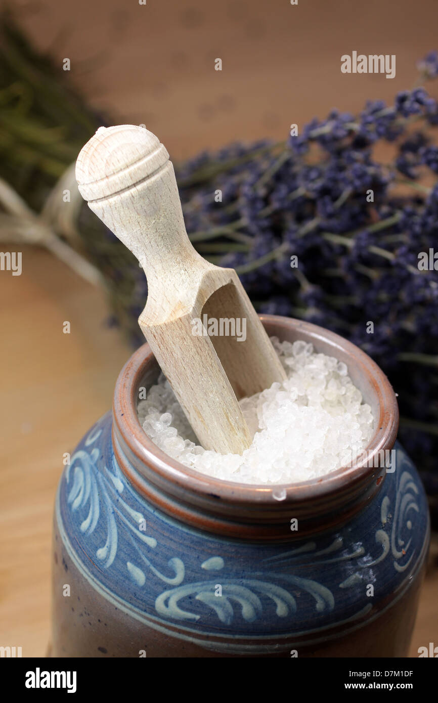 Bath salt in blue ceramic vessel on wooden desk with lavender and small wooden shovel Stock Photo