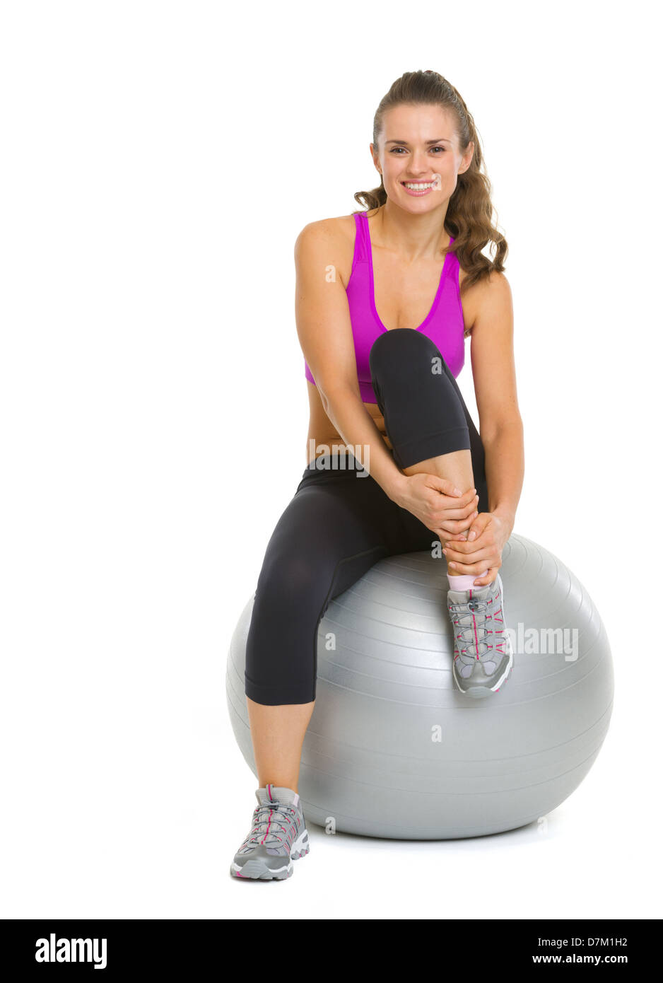 Happy fitness young woman sitting on fitness ball Stock Photo - Alamy