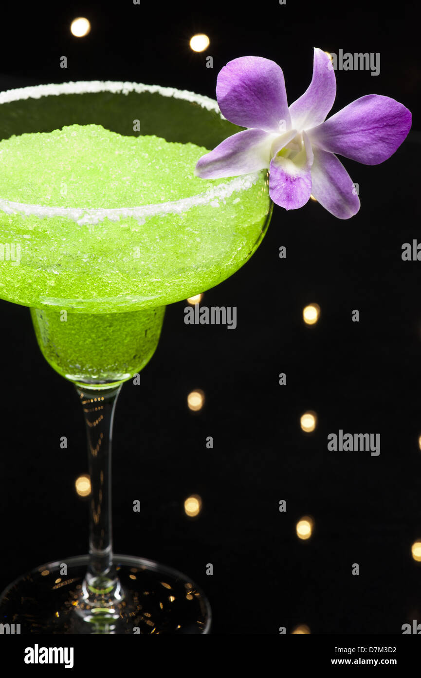 Green margarita cocktail in front of disco lights Stock Photo Alamy