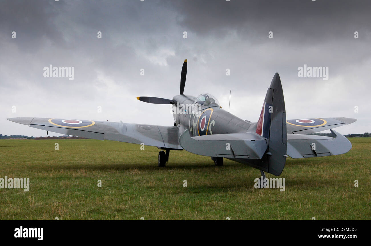 Supermarine Spitfire faces the gathering storm clouds on an airfield somewhere in England Stock Photo