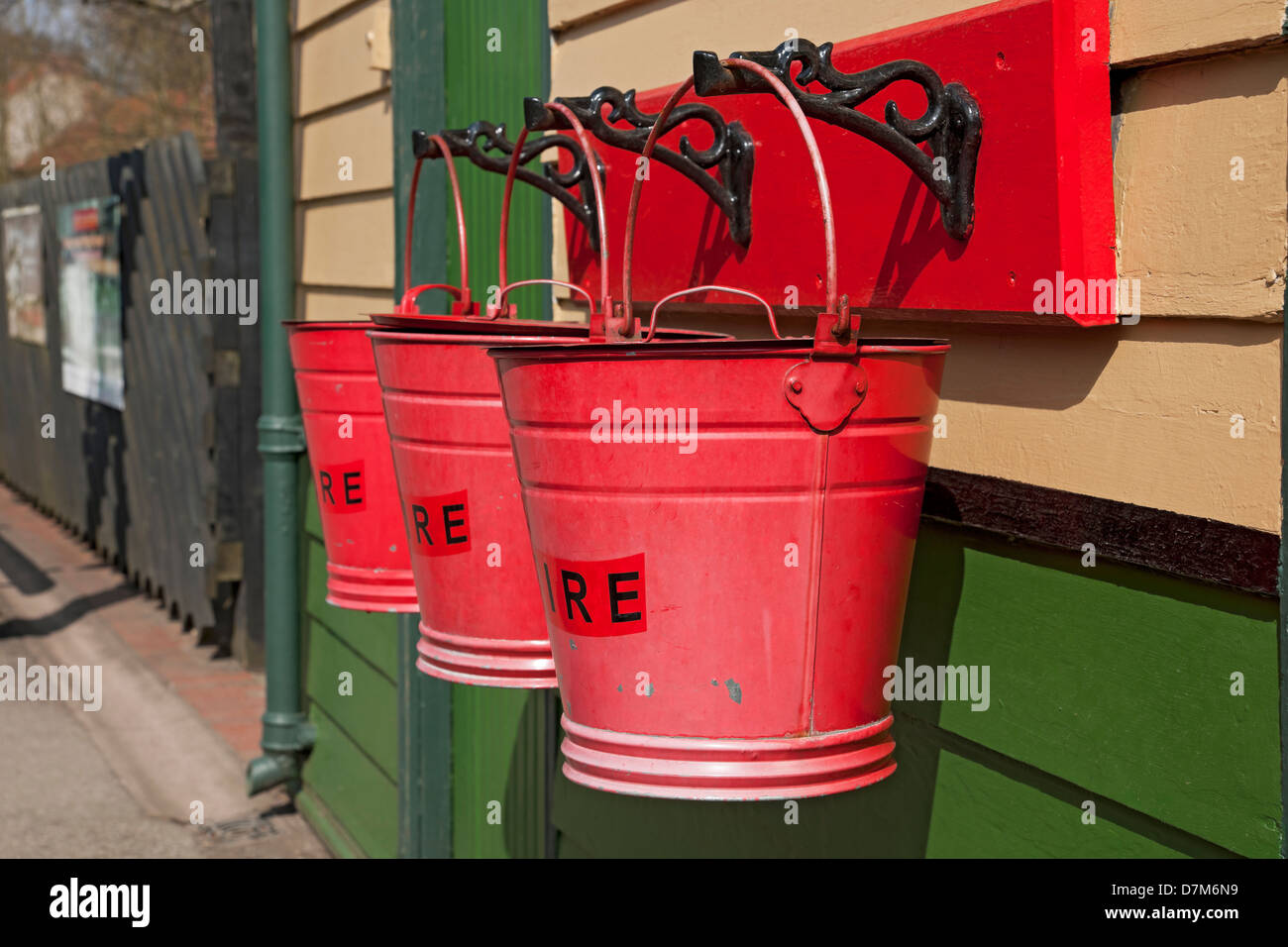 Close up of Three traditional red fire buckets bucket at Pickering Railway Train Station North Yorkshire England UK United Kingdom GB Great Britain Stock Photo