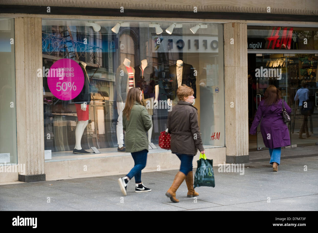 Shoppers walking past H&M store on busy high street in Exeter Devon England  UK Stock Photo - Alamy