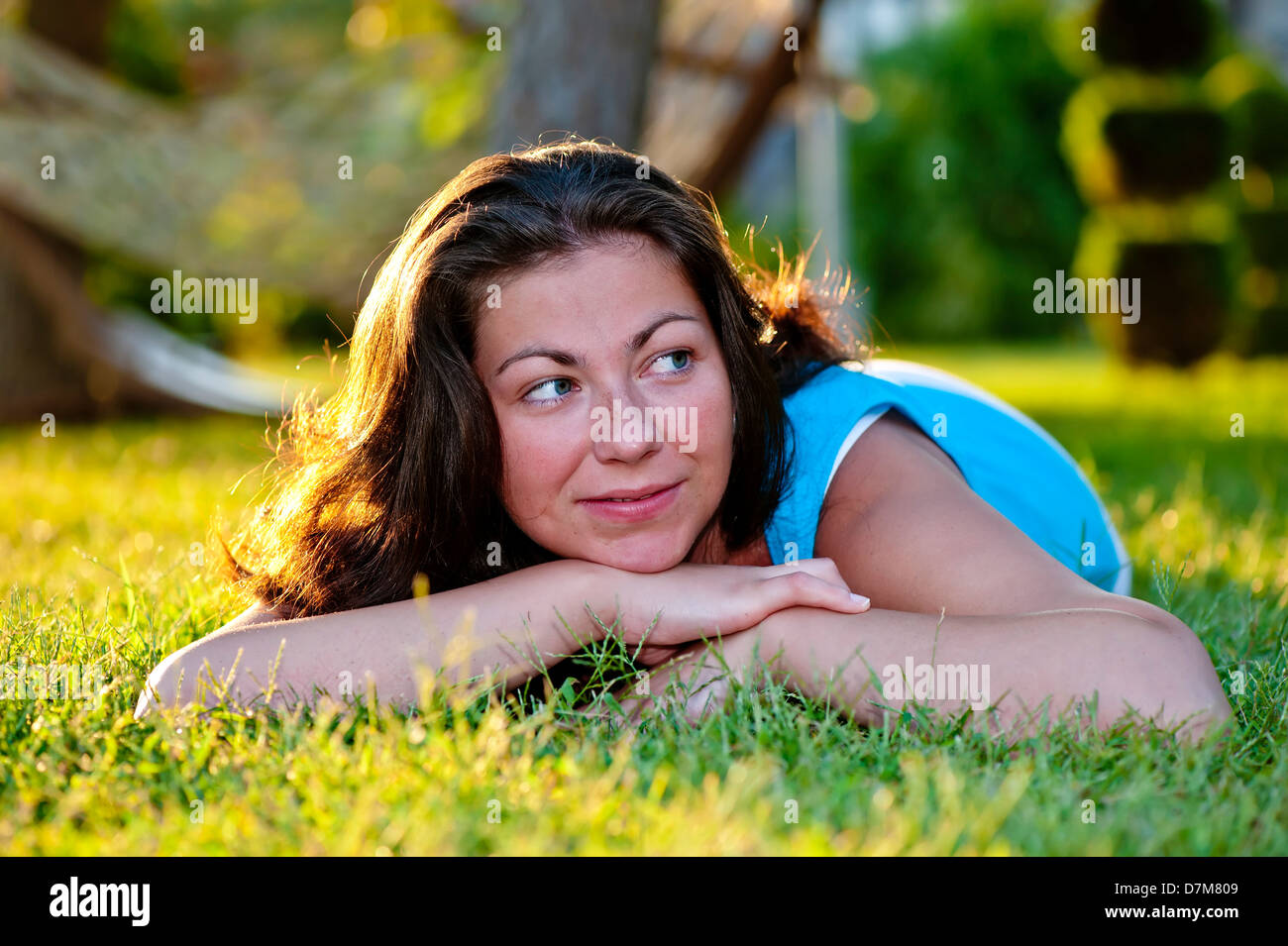 Brunette girl lying on the grass Stock Photo