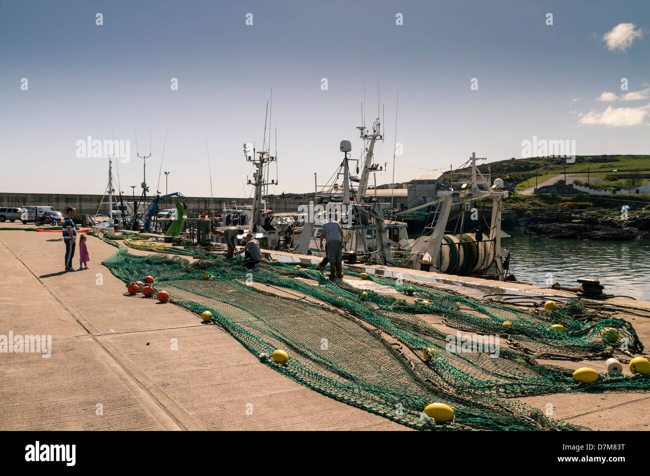 Nets being mended and prepared prior to fishing trip Stock Photo