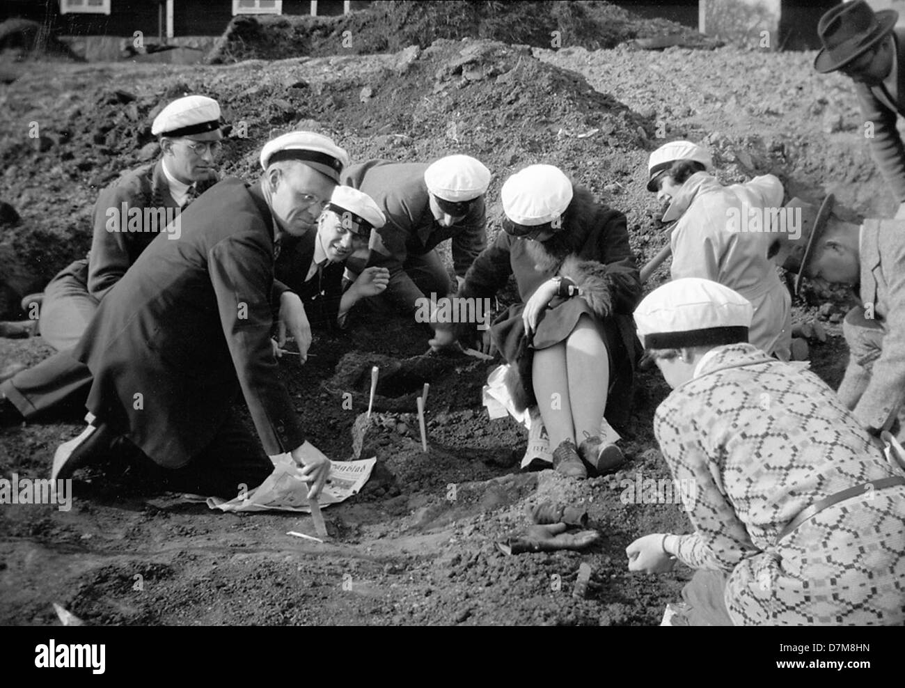 Archaeologists at a dig site in Tuna, Uppland, Sweden, examining a ...