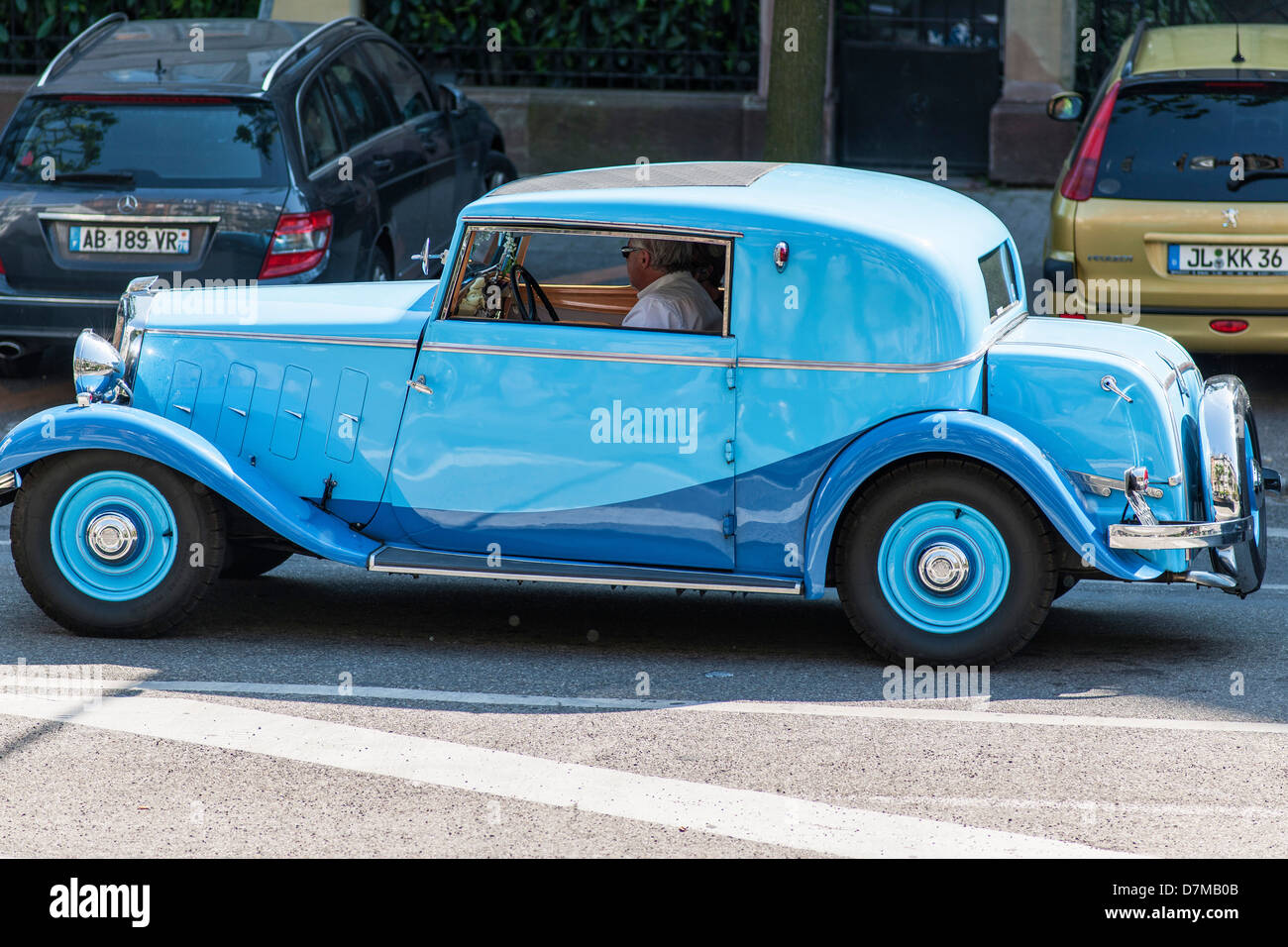 Man driving a 1933 Mathis EMY4- F 'Coupé Deauville' French vintage car Stock Photo