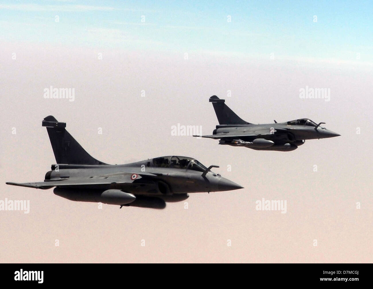 Two French Air Force Rafale fighter aircraft fly in formation as they prepare to take on fuel from a US Air Force KC-135R Stratotanker May 3, 2013, over Mali. Stock Photo