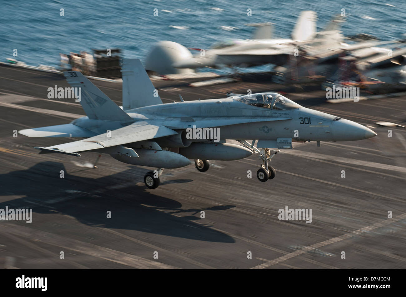 A US Navy F/A-18C Super Hornet lands on the flight deck of the aircraft carrier USS Nimitz May 8, 2013 underway in the Western Pacific. Stock Photo