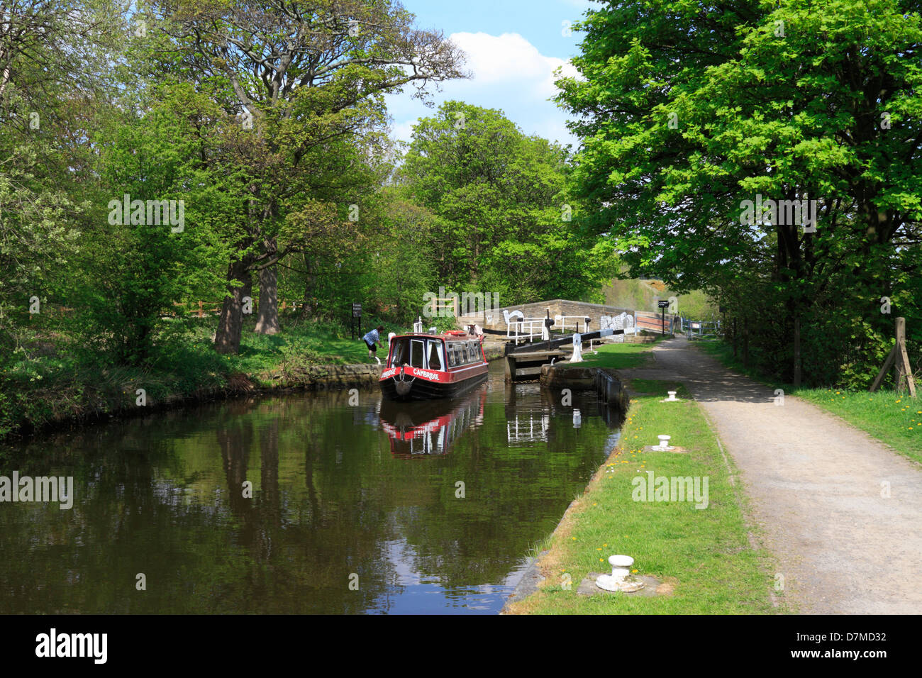 Narrow boat passing through lock gates on the Huddersfield Broad Canal, Huddersfield, West Yorkshire, England, UK. Stock Photo