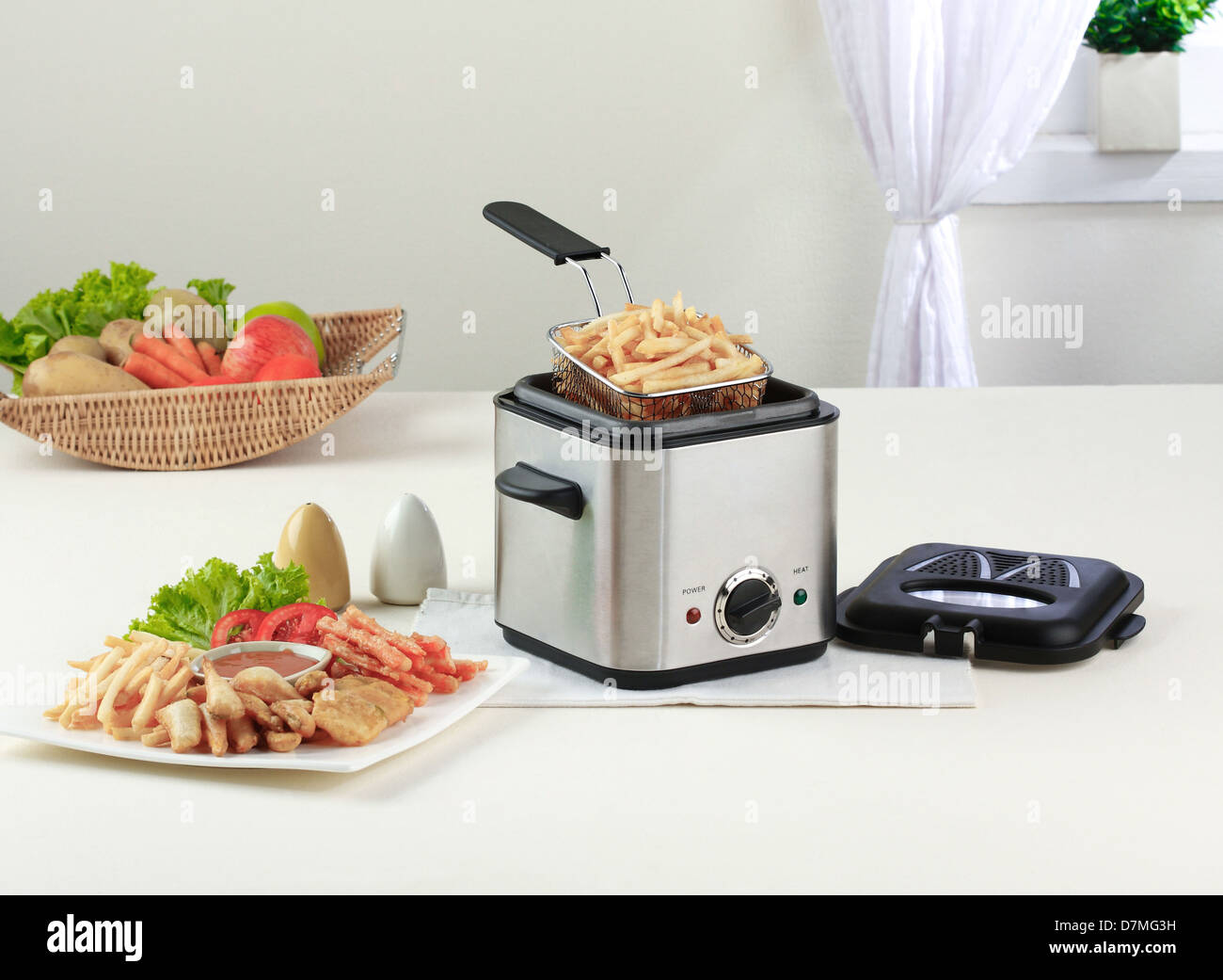 Let's do your French fry by using deep fryer machine comfortable and fast Stock Photo