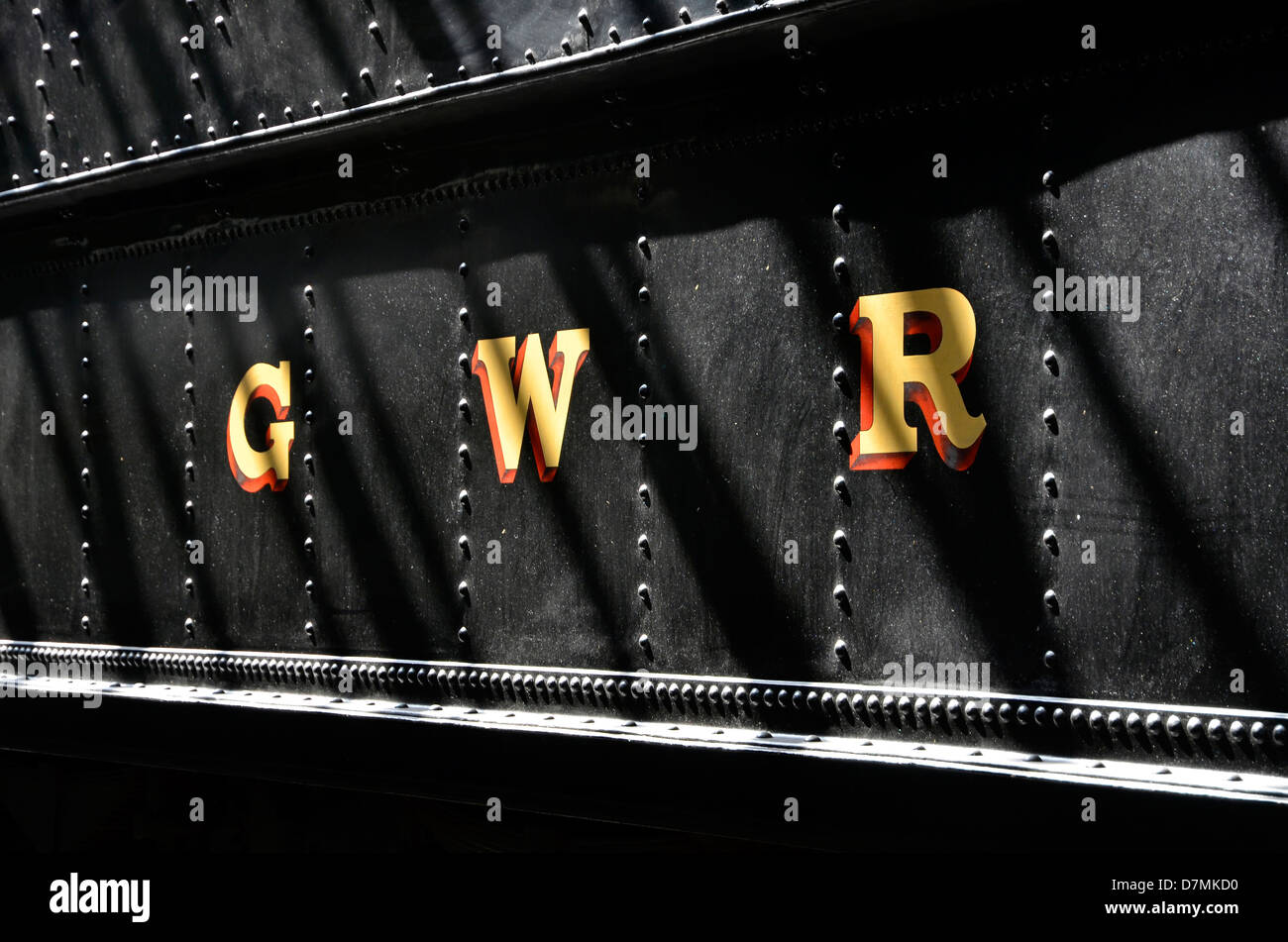 GWR -  Great Western Railway lettering on wartime black painted tender of steam loco in the running shed, Didcot Railway Centre. Stock Photo