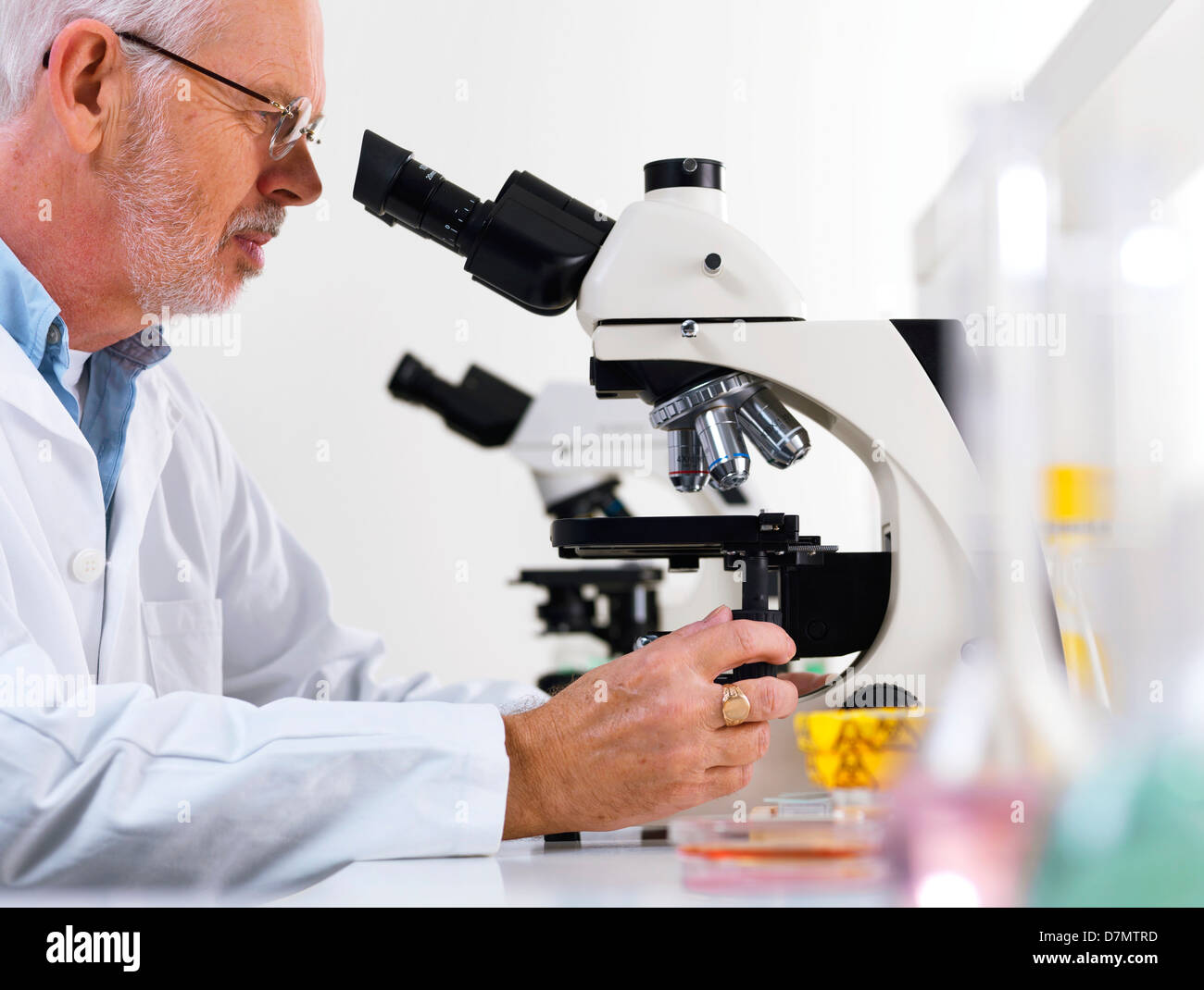 Scientist using a light microscope Stock Photo