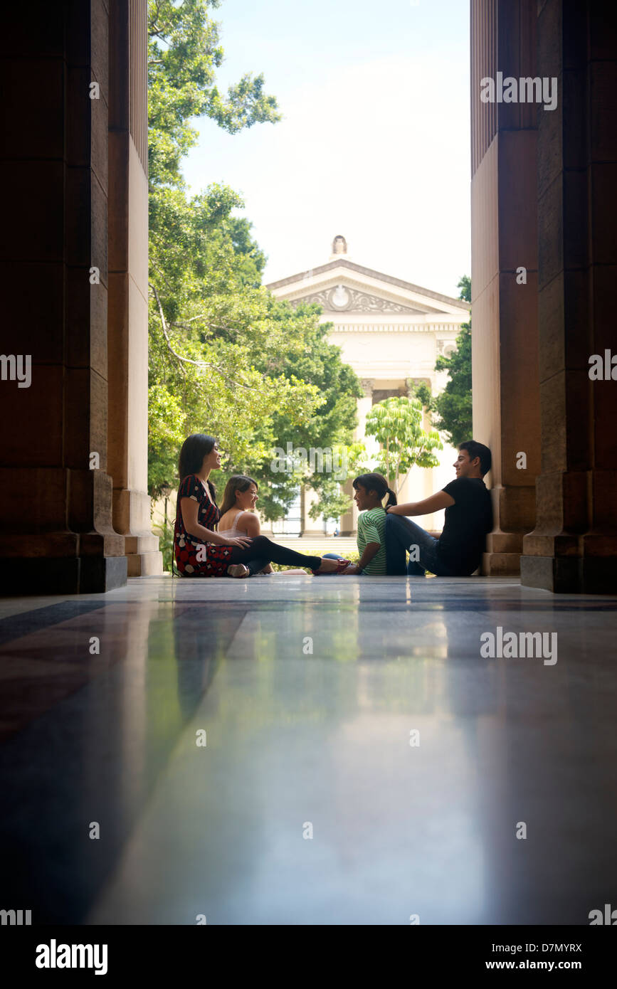 Education and students in university, group of young men and women talking and relaxing in college Stock Photo