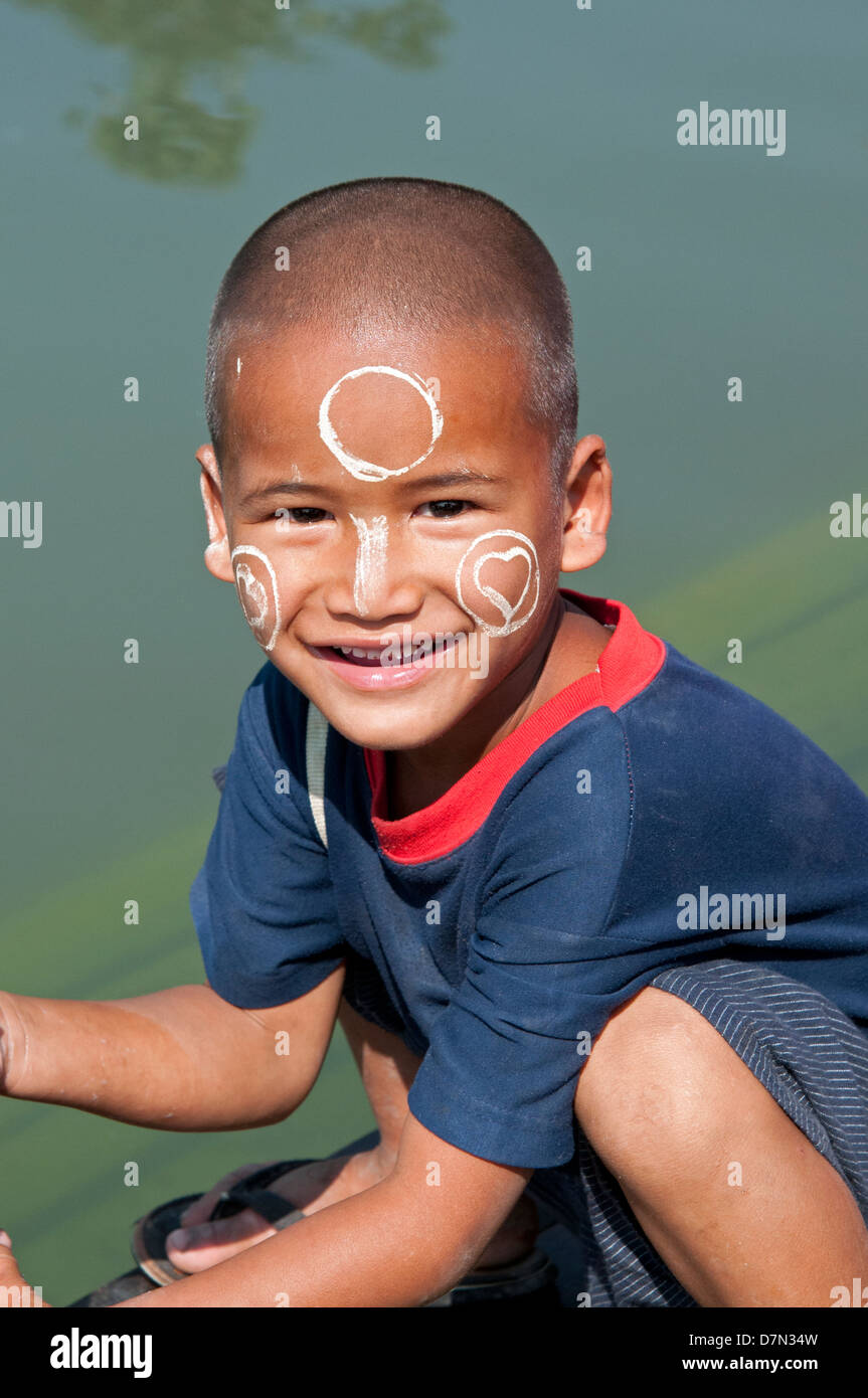 Small boy with thanakha face paste smiling at the camera Myanmar (Burma) Stock Photo