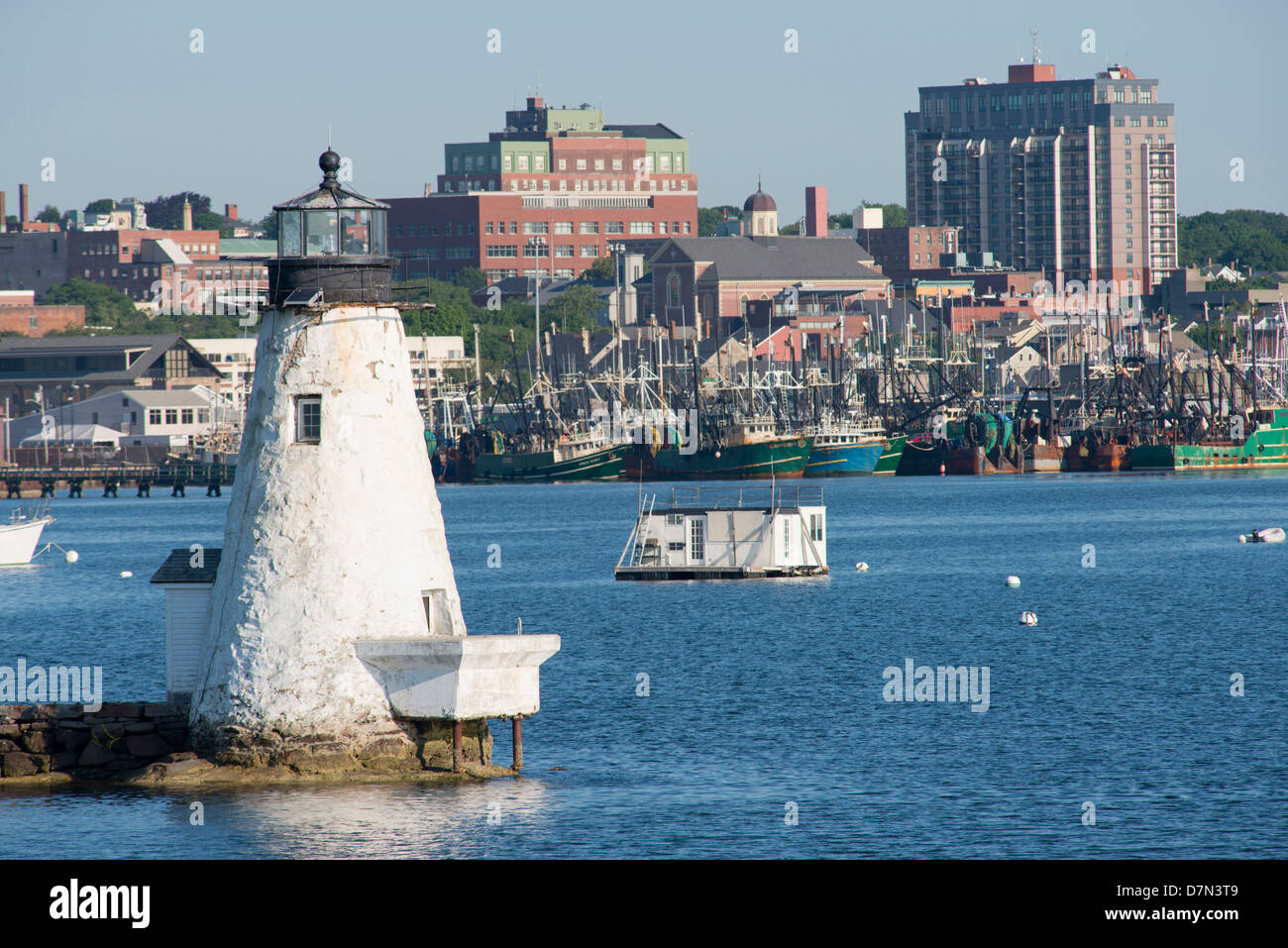 Massachusetts, New Bedford. New Bedford Harbor filled with commercial fishing boats with Palmer Island Lighthouse. Stock Photo