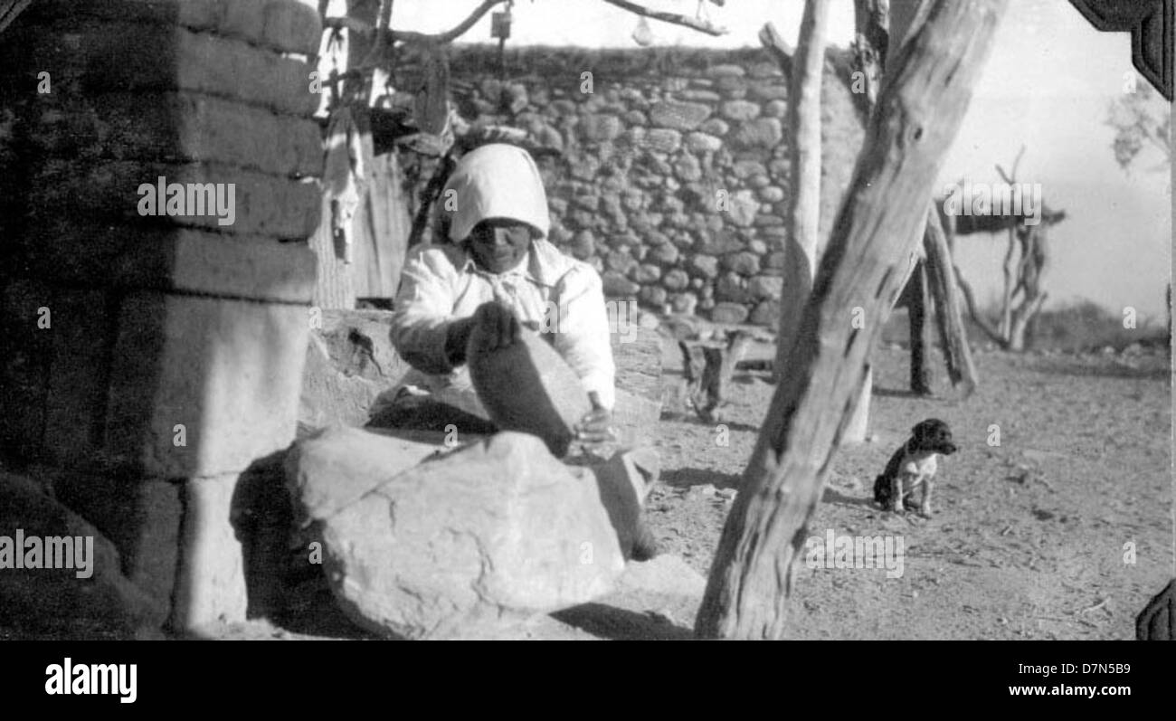 This image features a woman grinding corn while Elmer Riggs and Felipe ...