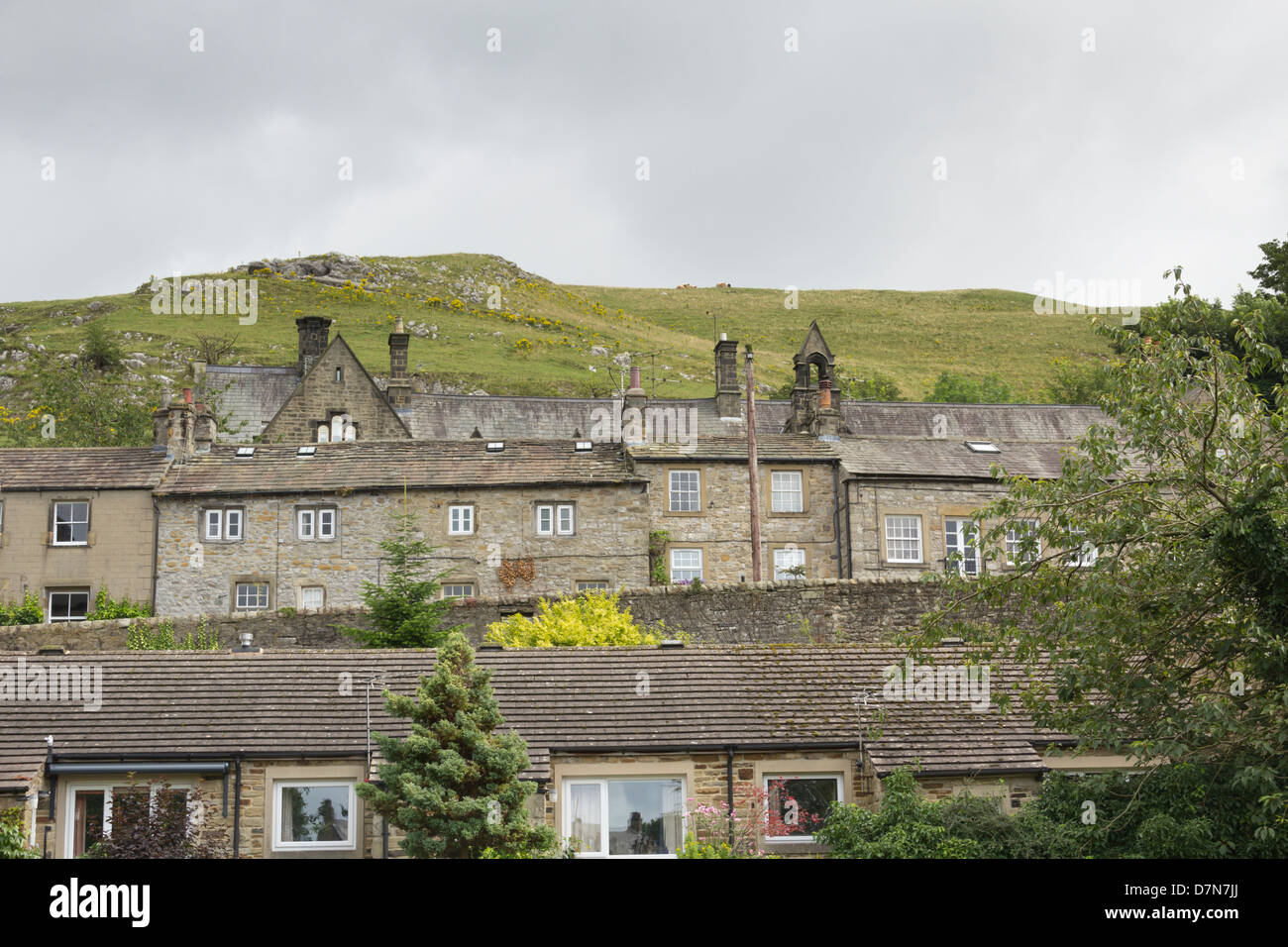 Stone-built houses and school of Settle, North Yorkshire, overlooked by hills of the north Yorkshire dales. Stock Photo