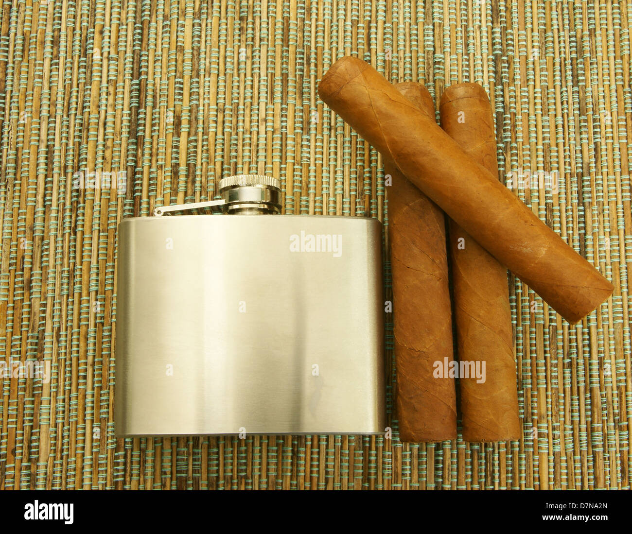 Close up of Cuban cigars and stainless steel hip-flask Stock Photo