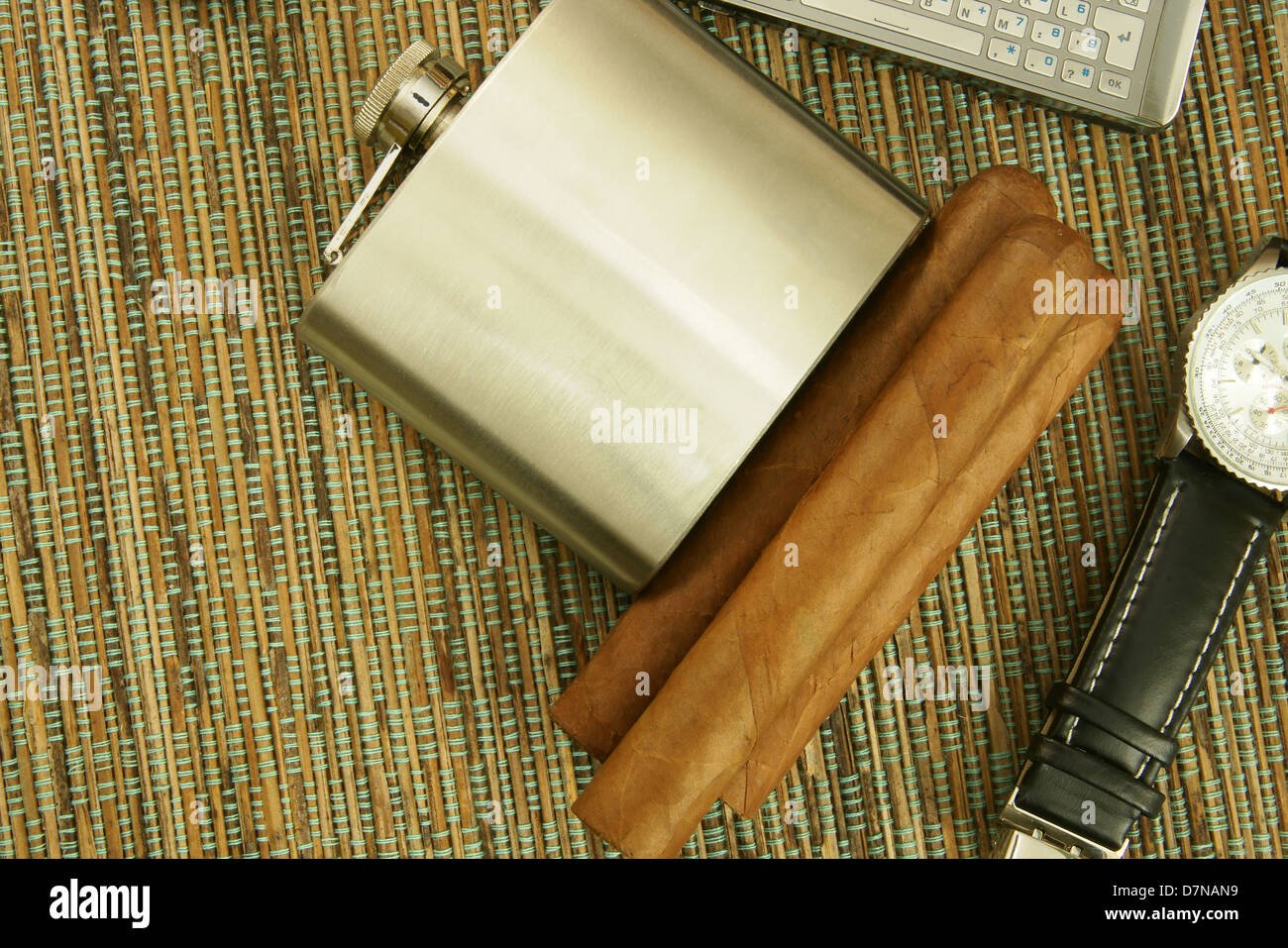 Close up of Cuban cigars, stainless steel hip flask, elegant wristwatch and cell phone Stock Photo
