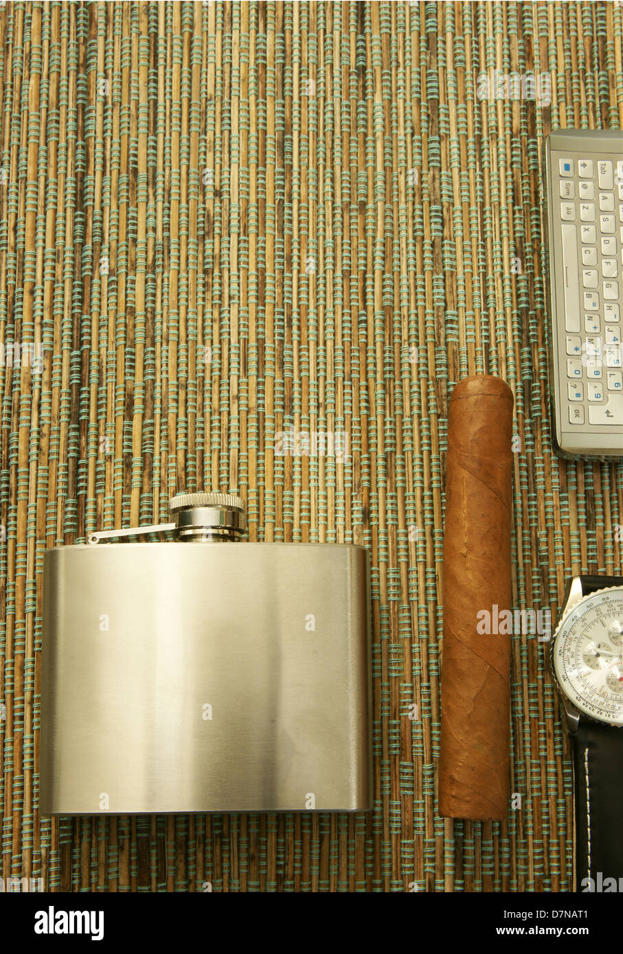 Close up of cigar, hip flask, wristwatch and phone Stock Photo