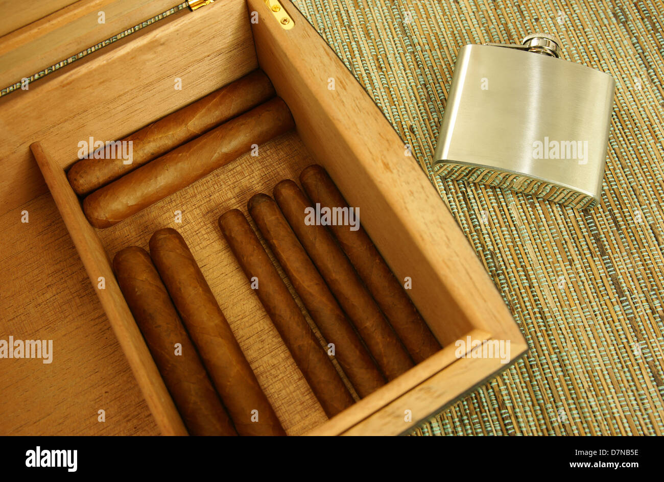 Cigars in open humidor. Hip-flask. Close-up. Stock Photo