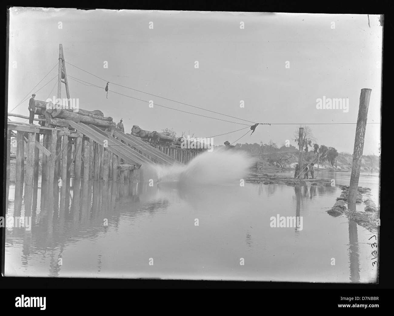 Old Log Ramp A photograph depicting men rolling logs down a ramp as part of a lumber ...