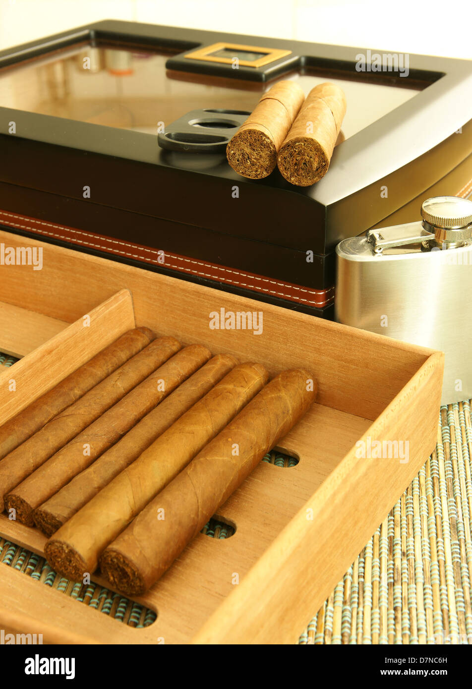 Cigars on cigar tray, cigar humidor, hip flask. Close up. Stock Photo