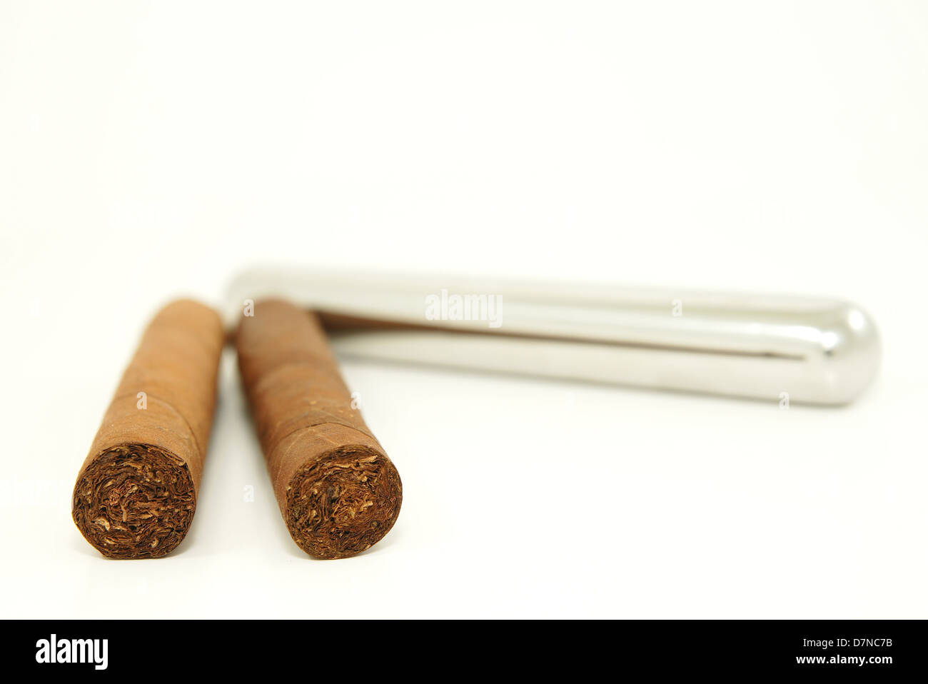 Close-up of two cigars and a stainless steel tube container Stock Photo