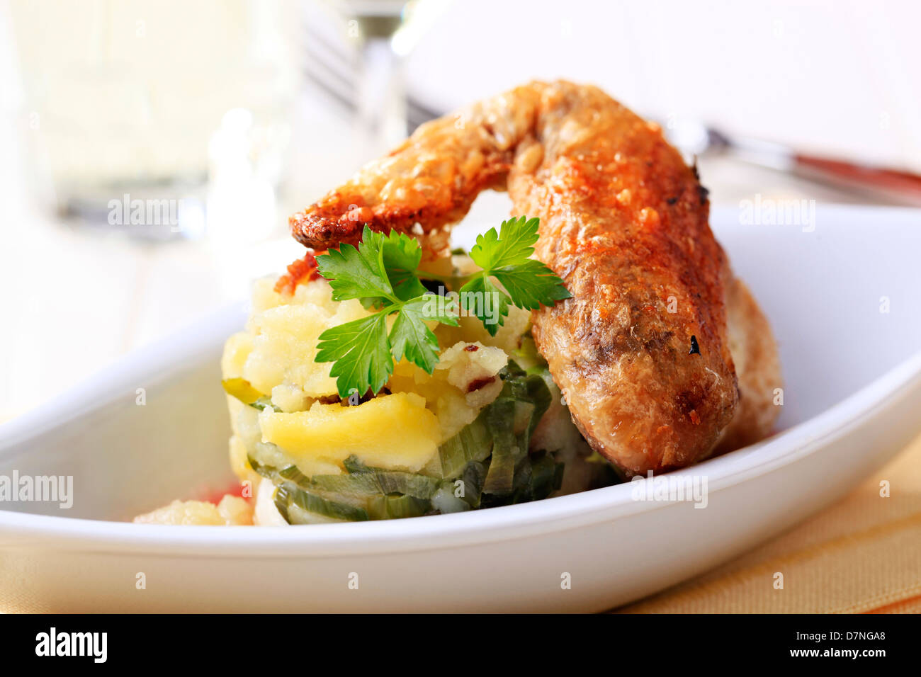 Roast chicken wing and potatoes - detail Stock Photo