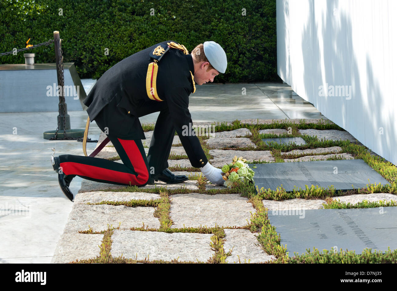 HRH Prince Harry of Wales places flowers at President John F. Kennedy's gravesite at Arlington National Cemetery May 10, 2013 in Arlington, VA. Stock Photo
