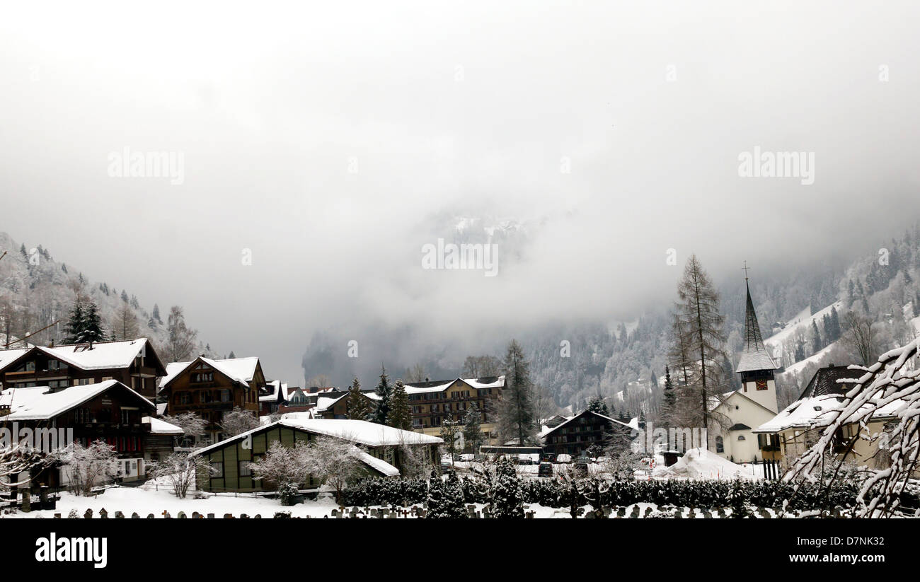 Village in the Alps and the fog in the mountains of Switzerland Stock Photo