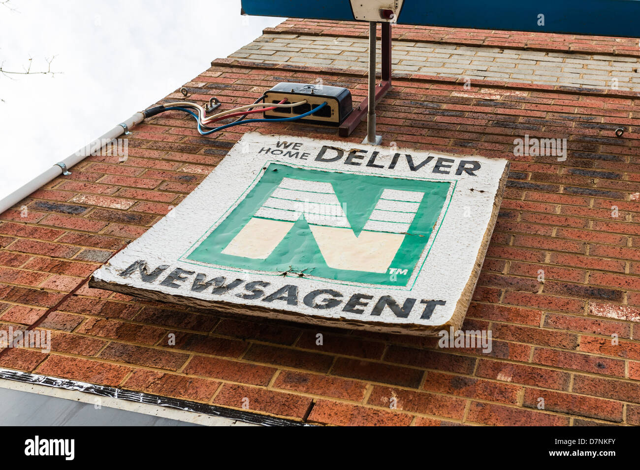 Dilapidated newsagent sign advertising home delivery. Conceptual image suggesting changing media  to non-paper alternatives Stock Photo