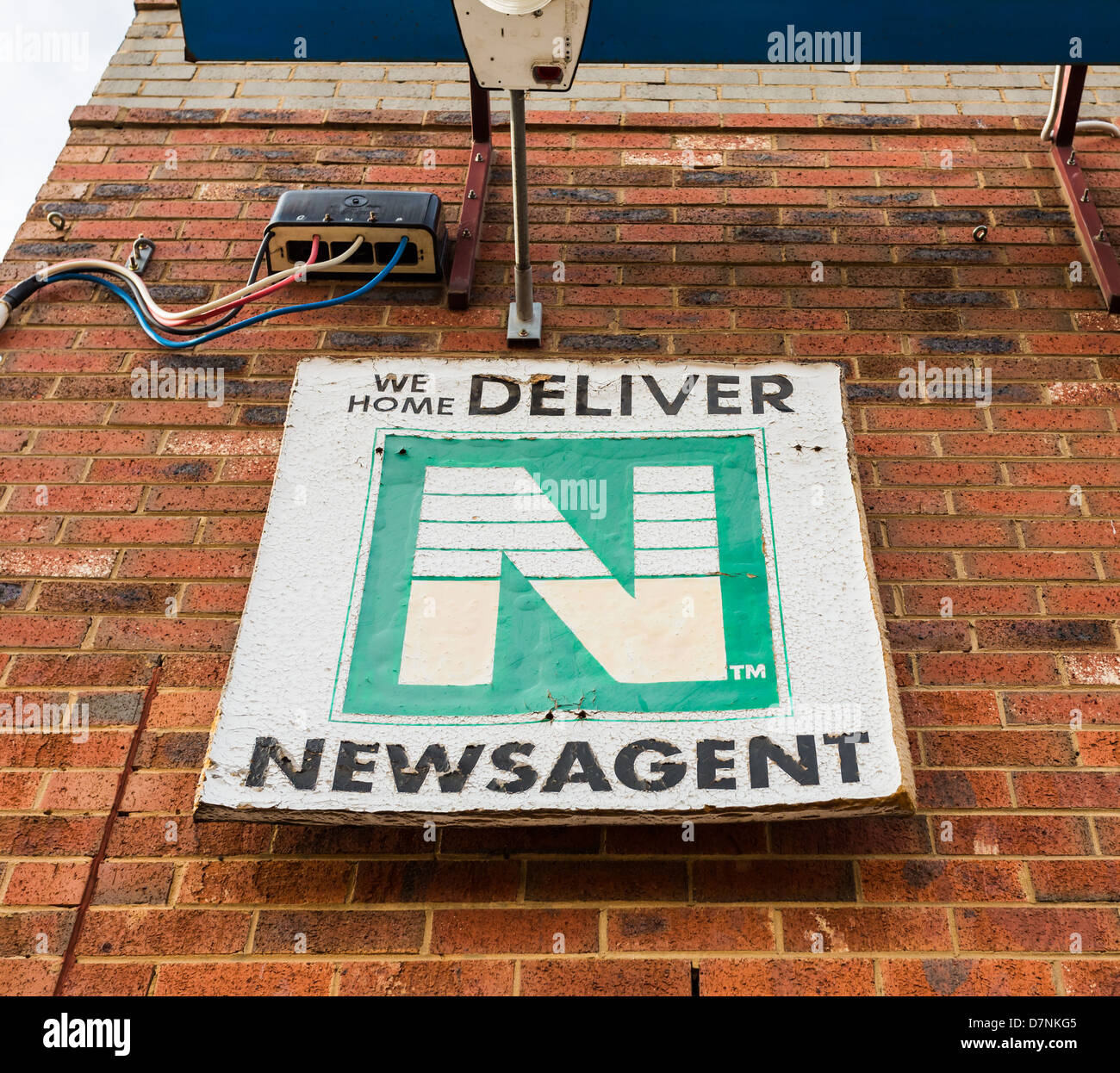 Dilapidated newsagent sign advertising home delivery. Conceptual image suggesting changing media  to non-paper alternatives Stock Photo