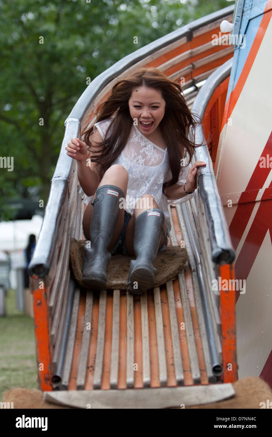 A YOUNG LADY FESTIVAL GOER/ FESTIVALGOER ON THE HELTER SKELTER AT LOVEBOX FESTIVAL , VICTORIA PARK, LONDON, 2012 Stock Photo