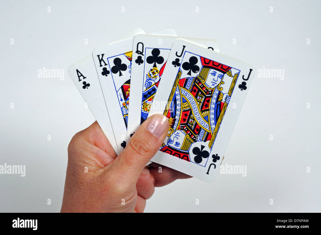 Woman holding playing cards, Ace, King, Queen and Jack of Clubs