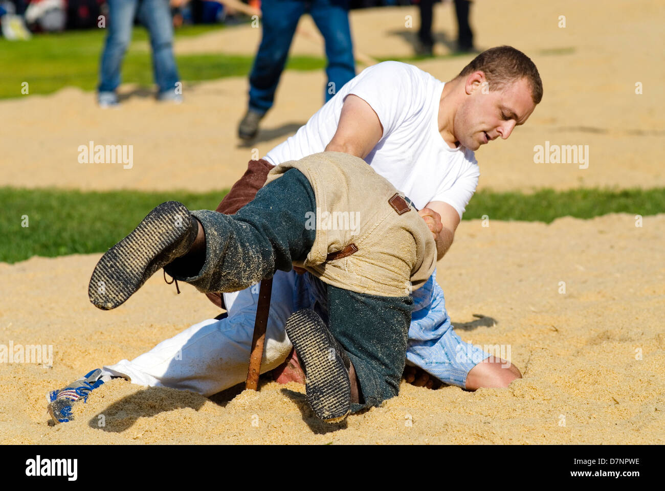 Schwingen (Swiss wrestling) at folklore festival, with spectators in background Stock Photo